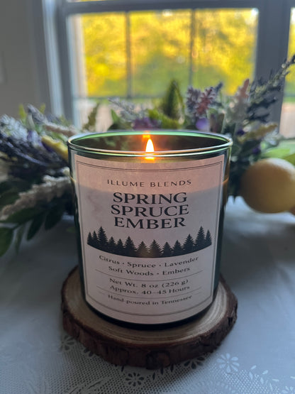 Spring Spruce Ember candle burning beside lavender and citrus styling near a window.
